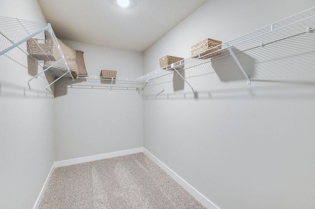 Primary bedroom features a large walk-in closet. *Pictures are of a model home, actual colors and finishes may vary. | Image 23