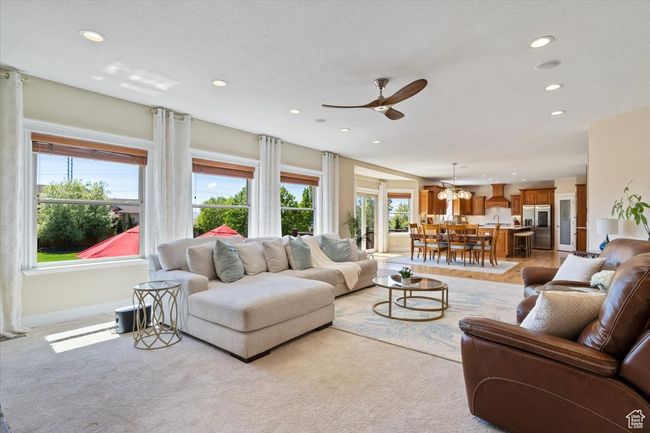 Living area featuring recessed lighting, a ceiling fan, light carpet, and baseboards | Image 11