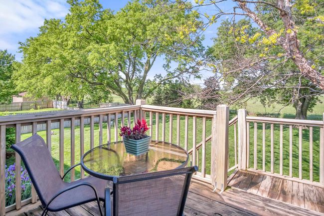 Deck with outdoor dining area and view of wooded area | Image 33