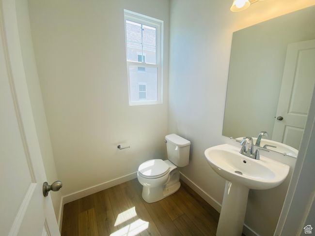 Bathroom with toilet and wood finished floors | Image 8