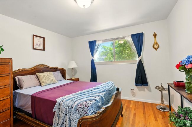 Bedroom featuring wood finished floors and baseboards | Image 15