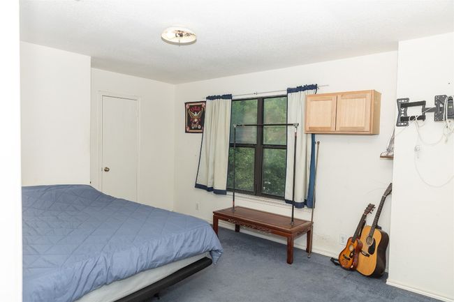 Carpeted bedroom featuring baseboards | Image 18