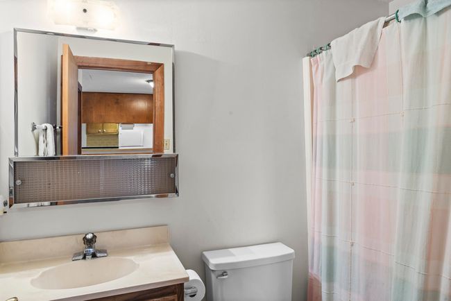 Bathroom featuring vanity and a shower with shower curtain | Image 32