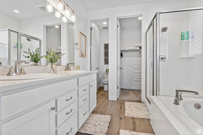 Bathroom with a stall shower, a sink, and toilet | Image 21