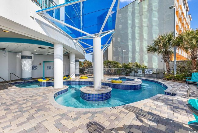 Community pool featuring fence, a community hot tub, and a patio area | Image 35