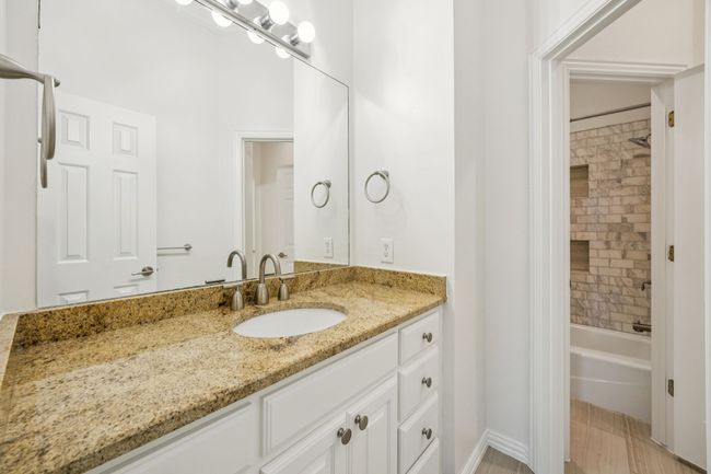 One side of Jack and Jill bathroom with vanity, shower / bath combination | Image 24