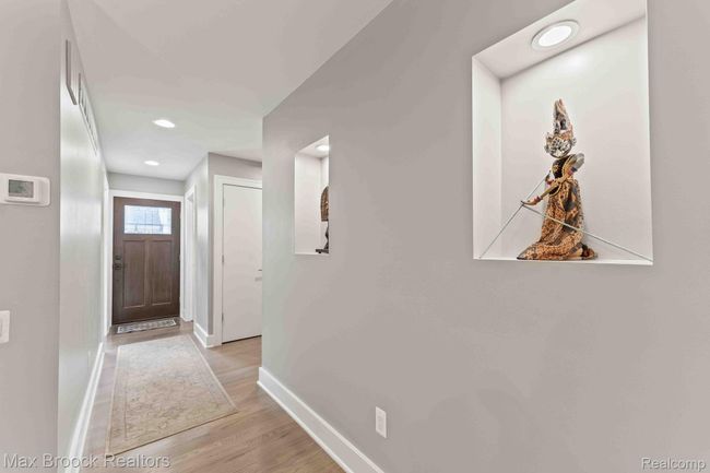 Elegant entry hallway with display niches and lighting. | Image 18
