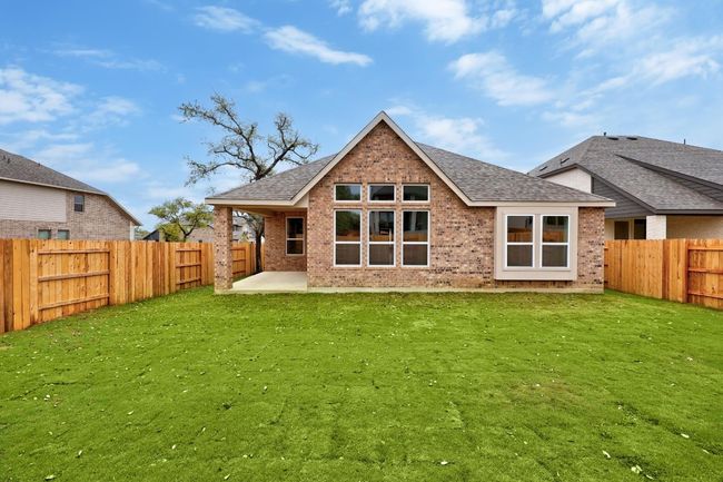 Rear view of property with brick siding, a shingled roof, a patio, and a fenced backyard | Image 21
