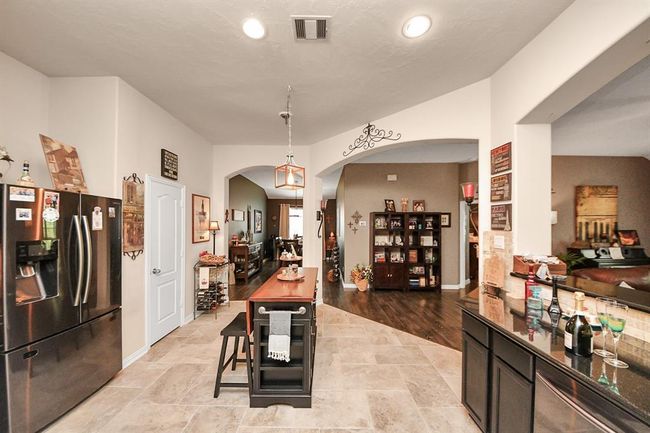 Kitchen with full bar open to entertainment room | Image 25