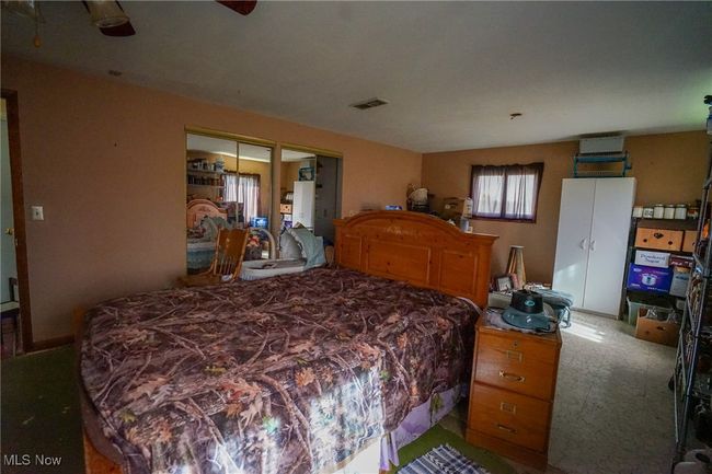 Bedroom with carpet, visible vents, and multiple closets | Image 14
