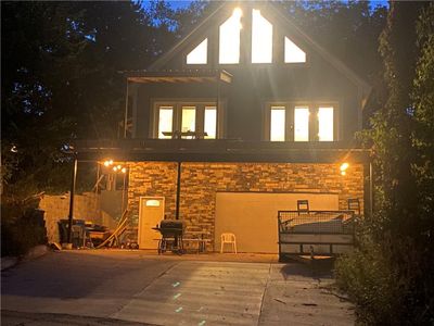 Front of house at twilight with a patio | Image 1