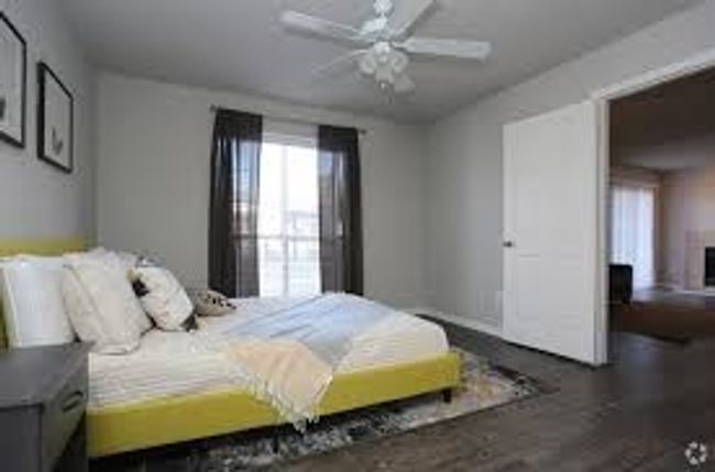 Bedroom with ceiling fan and wood finished floors | Image 4