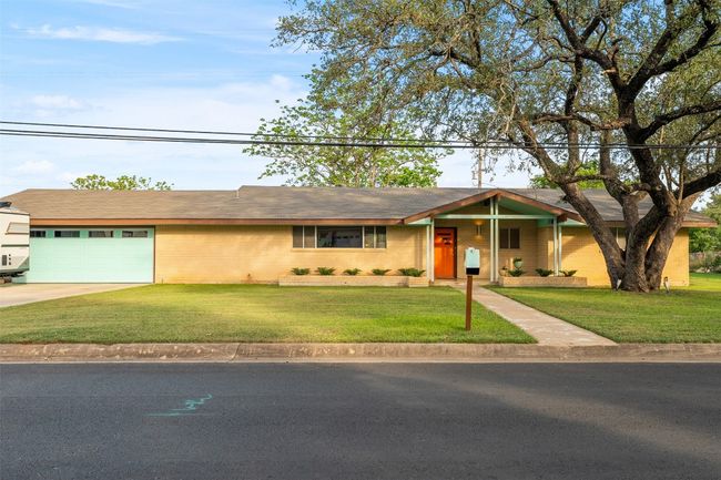 Ranch-style home featuring an attached garage, brick siding, a front yard, and concrete driveway | Image 4