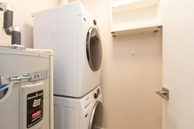 Clothes washing area featuring stacked washer / drying machine and laundry area | Image 17