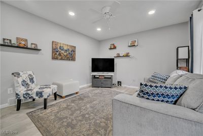 Living room with light hardwood / wood-style flooring and ceiling fan | Image 2