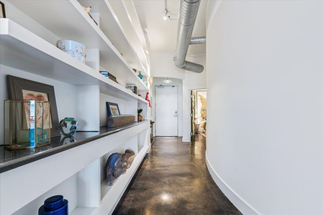 Hall with stained concrete flooring and 11' ceiling heights | Image 23