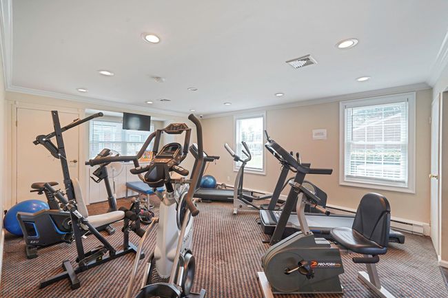 Gym with crown molding, recessed lighting, carpet, and baseboard heating | Image 32