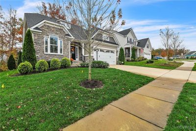 Craftsman-style house with a front lawn and a garage | Image 2