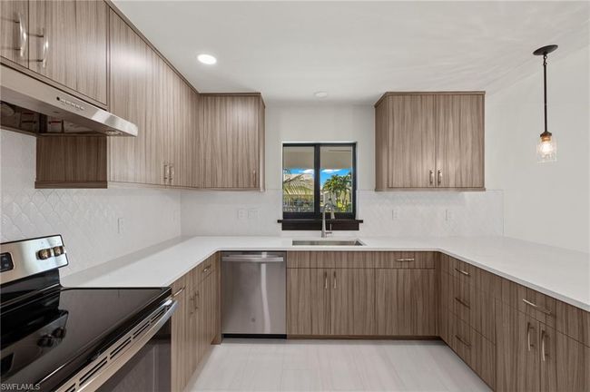 Kitchen with decorative light fixtures, decorative backsplash, sink, appliances with stainless steel finishes, and light tile patterned floors | Image 20