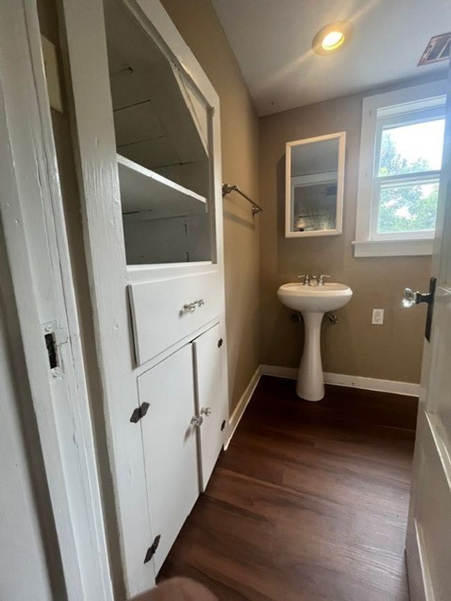 Bathroom with baseboards and wood finished floors | Image 31