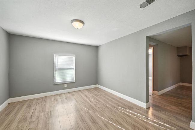 Spare room with wood finished floors and a textured ceiling | Image 13