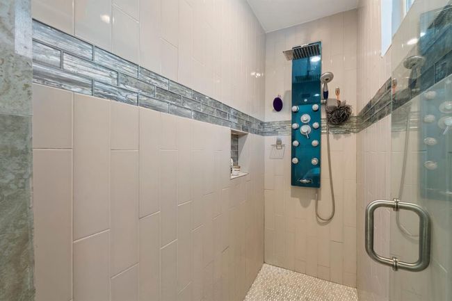 This photo showcases a modern shower, offering a spa-like experience. | Image 25