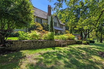 Part of expansive front yard with beautiful stone work, enhancing the charm of the home. | Image 2