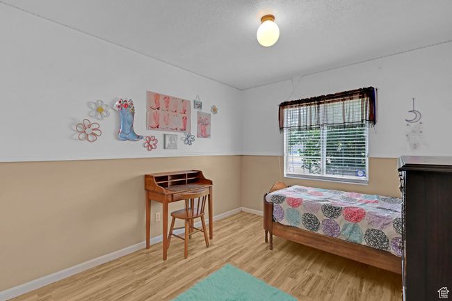 Bedroom featuring wood finished floors and baseboards | Image 18