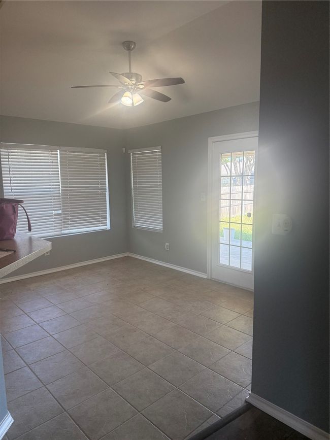 Unfurnished room featuring tile patterned flooring, ceiling fan, and baseboards | Image 27