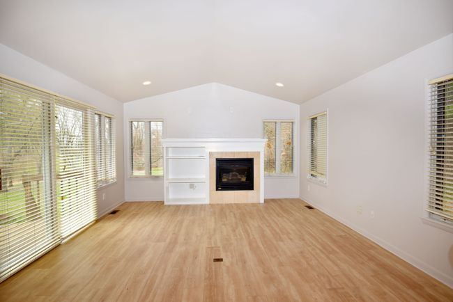 Kitchen opens to sitting area with cozy fireplace | Image 17