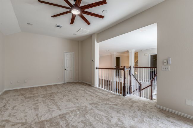 Spare room featuring a ceiling fan, carpet flooring, baseboards, and vaulted ceiling | Image 16