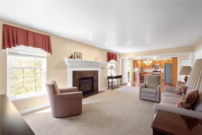 The marble surround is a beautiful addition to family room fireplace. | Image 15