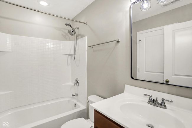 full bath with vanity and shower / bath combination. Entry to both the hallway and the primary bedroom | Image 26