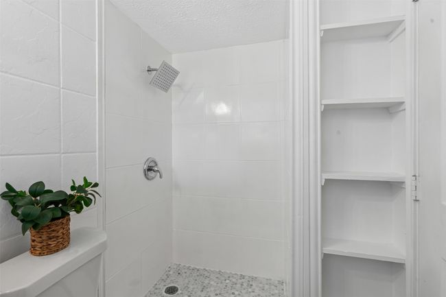 Full bathroom with a tile shower and a textured ceiling | Image 23
