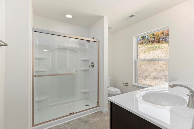 Bathroom with vanity, toilet, and an enclosed shower | Image 7