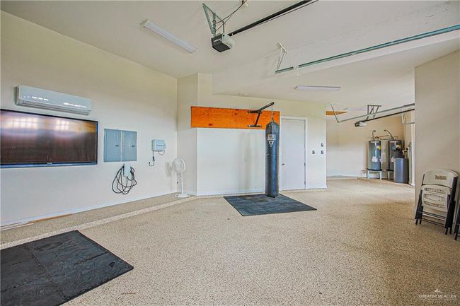 Three insulated 9x10 ft garage doors, 3-car garage (insulated, AC-equipped)overhead storage with polyurethane floors | Image 31