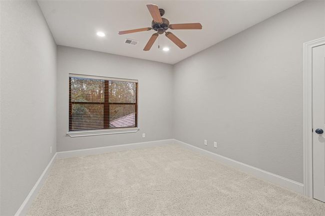 Inviting Upper-Level Bedroom with Ample Natural Light and Modern Ceiling Fan | Image 35