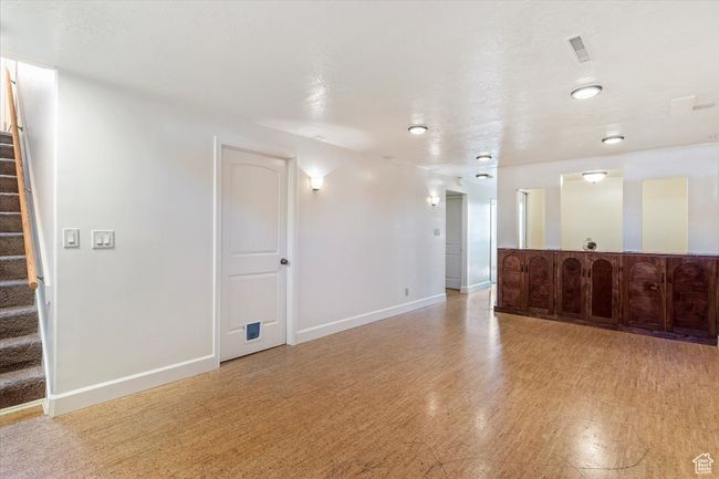 Unfurnished living room with stairway and light wood finished floors | Image 21