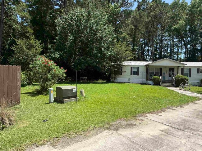 View of front facade with covered porch, a front lawn, and a metal roof | Image 9
