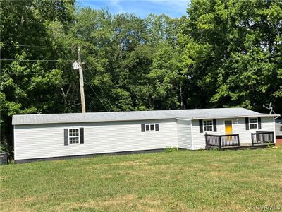 Front view of house featuring a deck and a lawn | Image 2