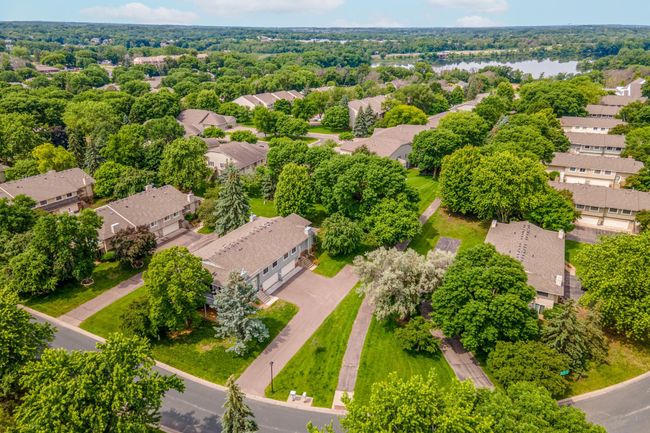Just steps from your door, enjoy scenic strolls on this peaceful, shaded walking path winding through the neighborhood's green spaces. | Image 4