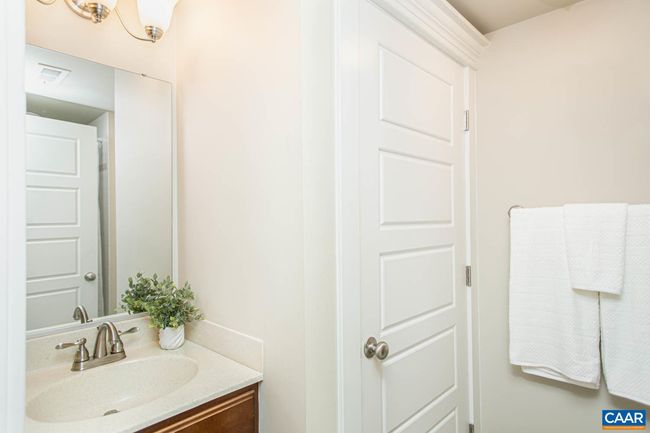 This bedroom/family room includes an attached bath. | Image 38