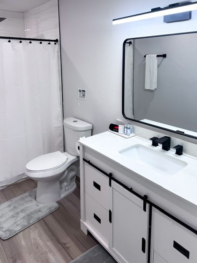 Bathroom with a shower with shower curtain, hardwood / wood-style floors, vanity, and toilet | Image 13