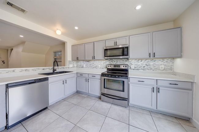 Kitchen offers ample cabinetry, providing plenty of storage space for all your cooking essentials. | Image 15