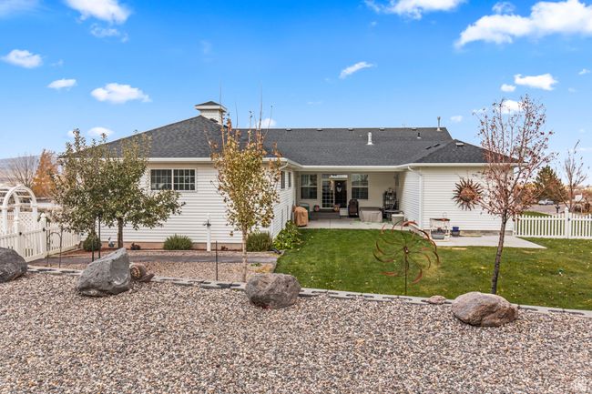 Rear view of house with a lawn and a patio | Image 12