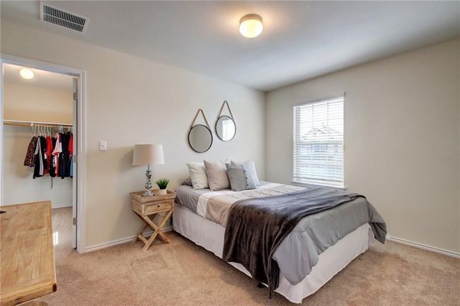 Bedroom featuring carpet, a spacious closet, and a closet | Image 25