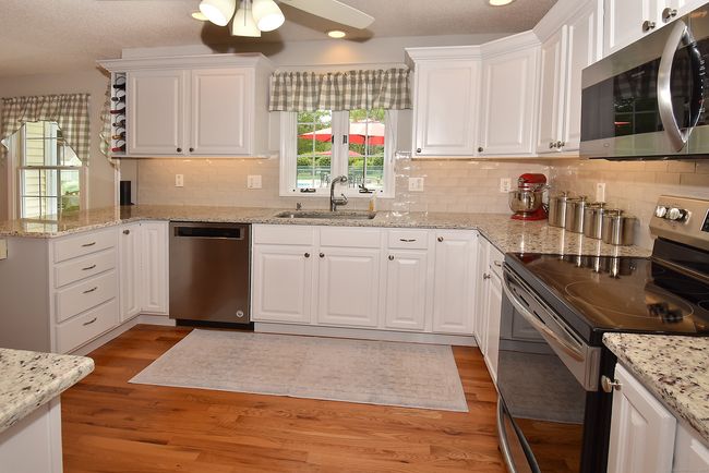 Kitchen features granite counters and newer appliances. | Image 12