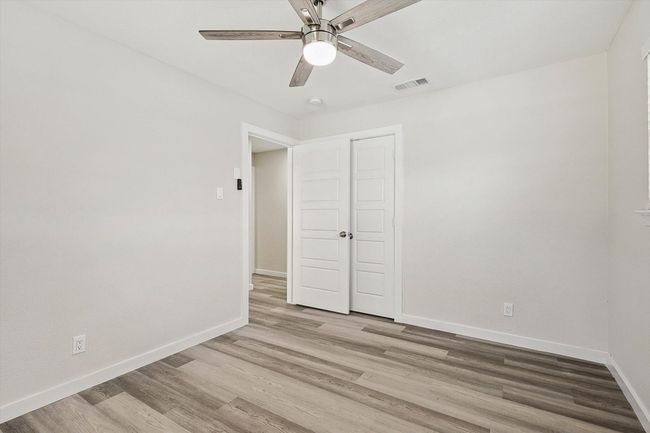 Unfurnished bedroom featuring light wood-style flooring, a closet, ceiling fan, baseboards, and visible vents | Image 30