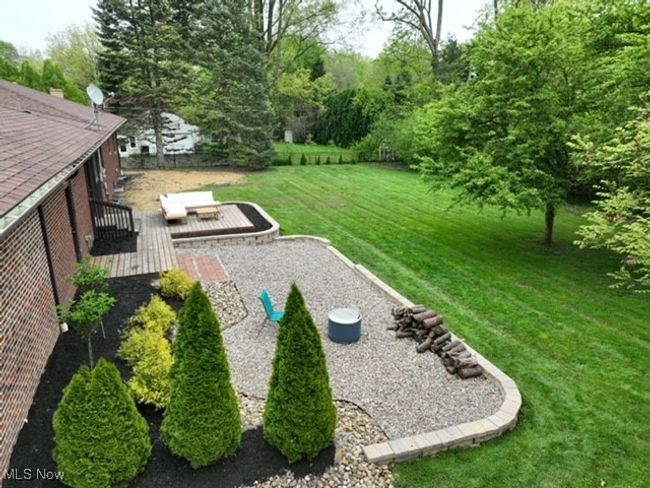 View of green lawn with a wooden deck | Image 5