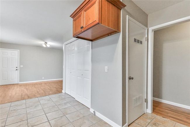 Kitchen with light tile patterned flooring | Image 6